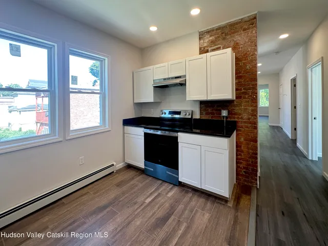 a kitchen with a sink stove and cabinets