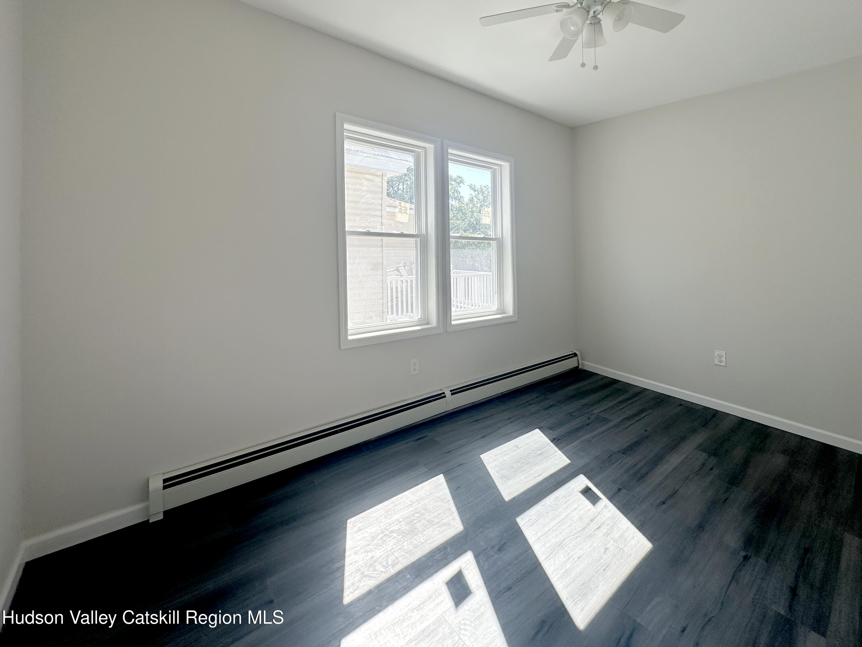 228 Mansion Street Poughkeepsie, NY 12601 - Photo 23 of 35 an empty room with wooden floor and windows