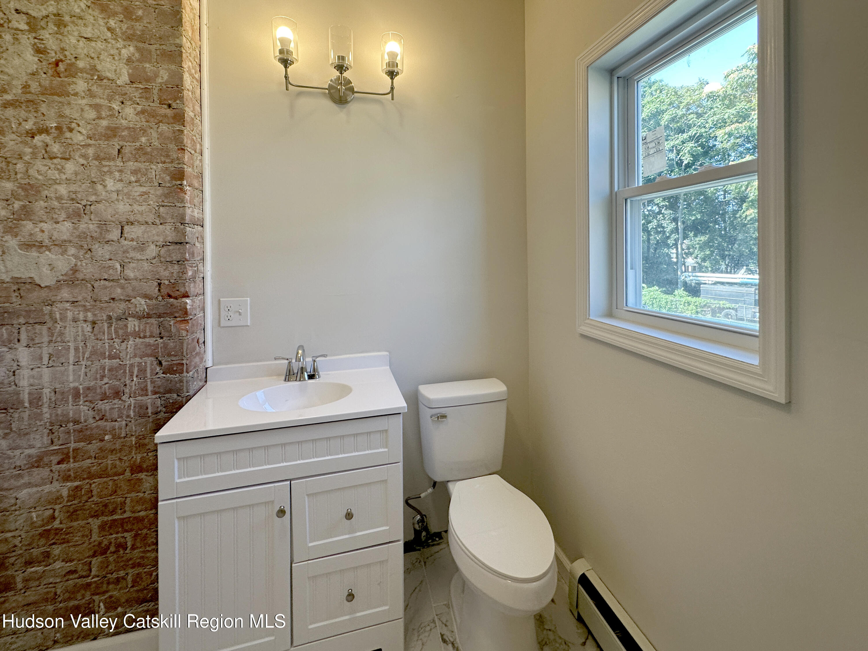 228 Mansion Street Poughkeepsie, NY 12601 - Photo 24 of 35 a bathroom with a sink toilet and a mirror