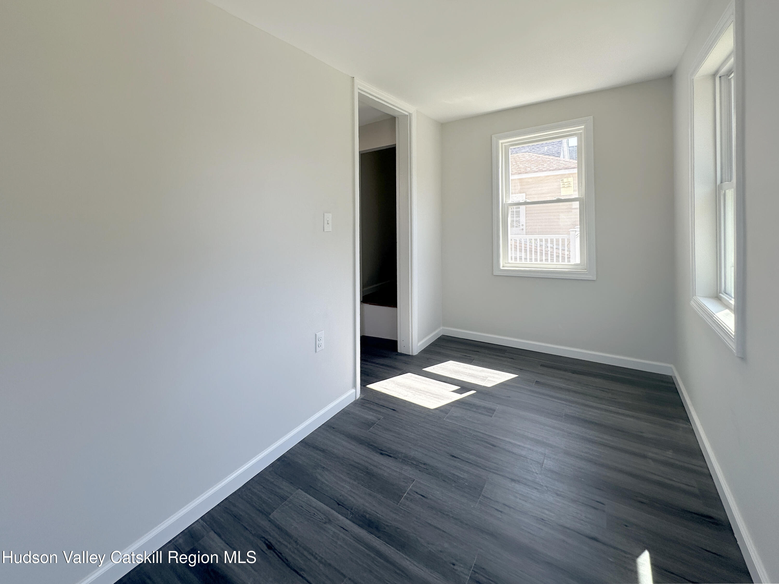 228 Mansion Street Poughkeepsie, NY 12601 - Photo 26 of 35 an empty room with wooden floor and windows