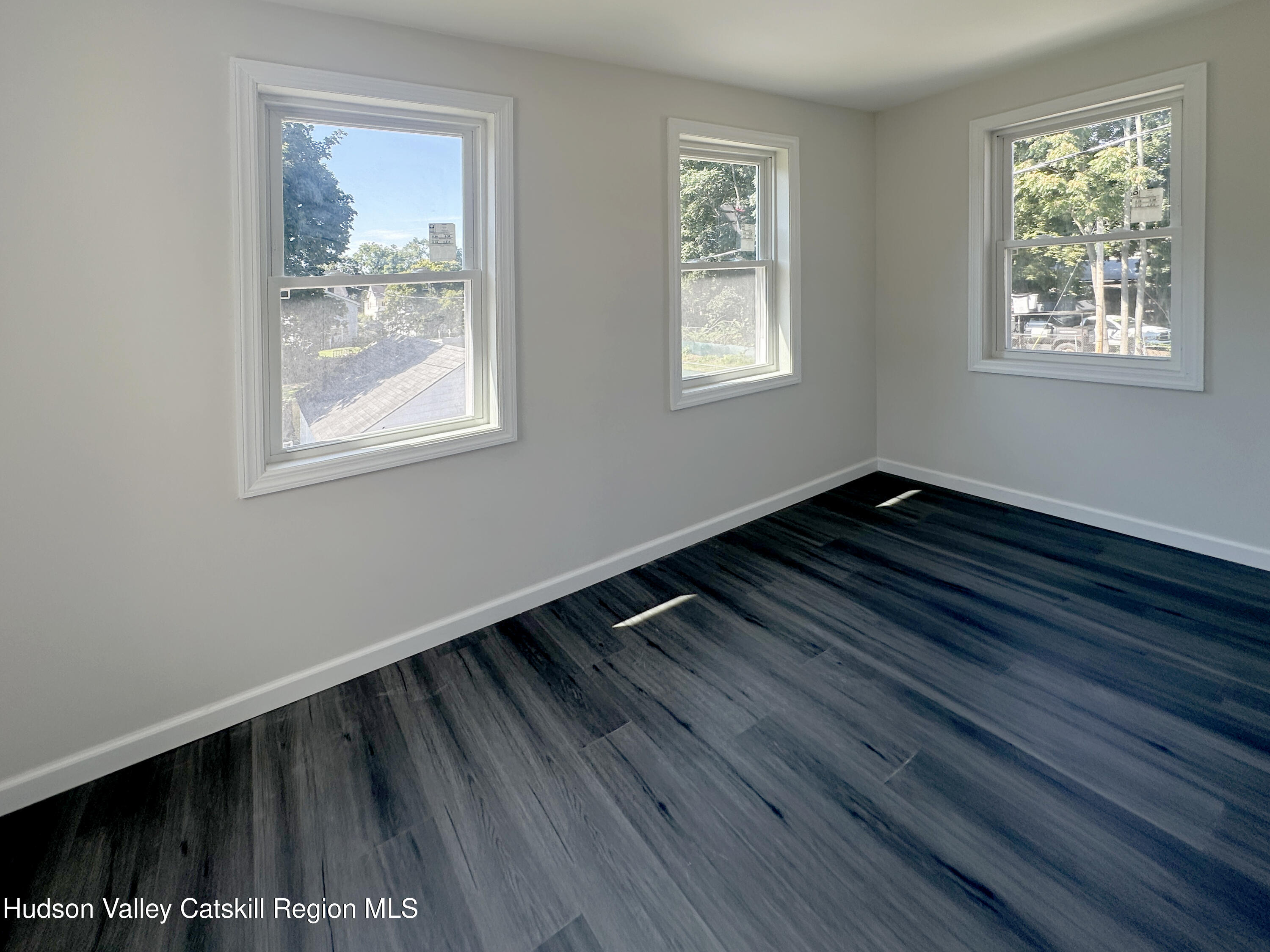 228 Mansion Street Poughkeepsie, NY 12601 - Photo 27 of 35 a view of an empty room with wooden floor and a window