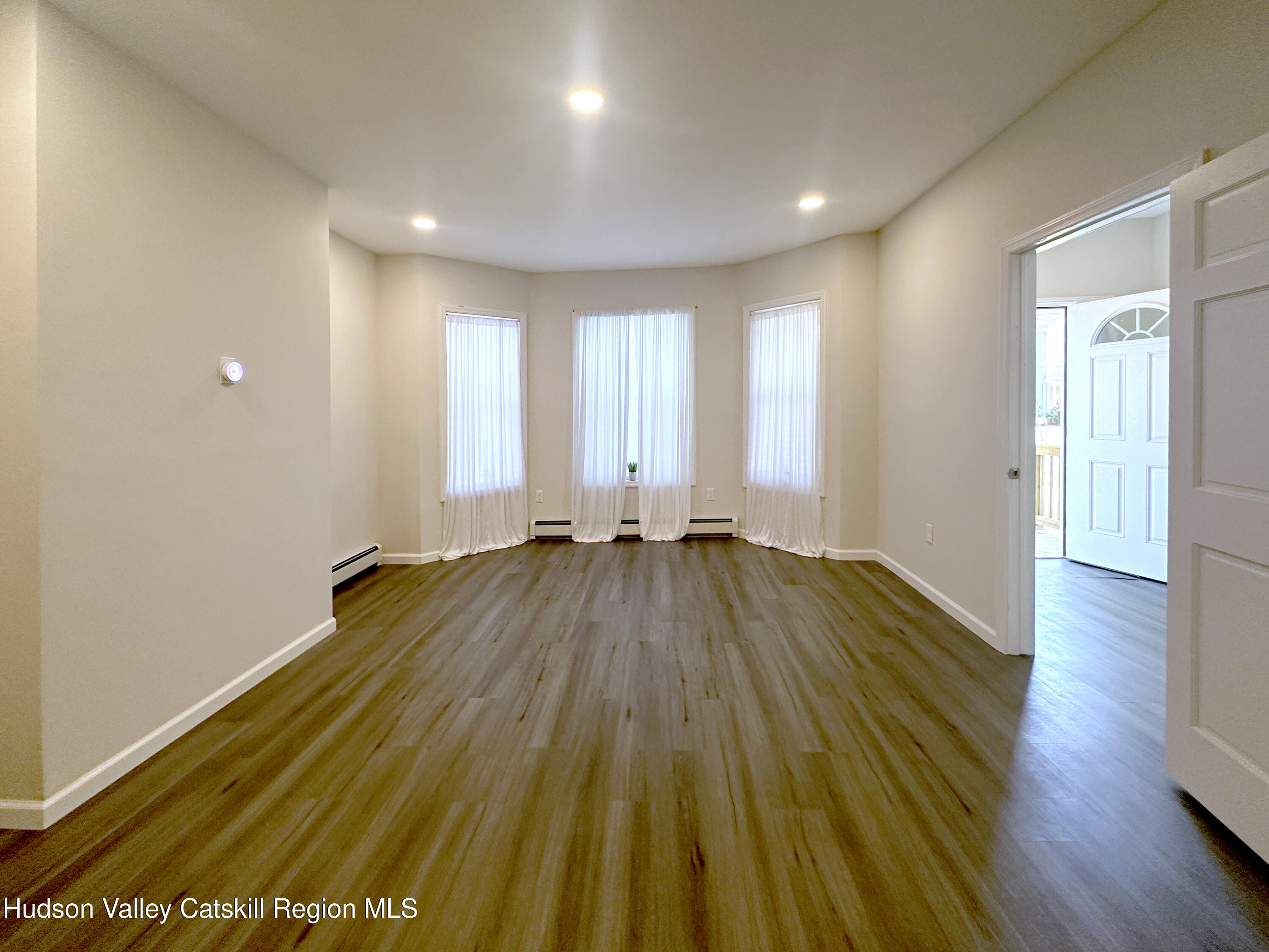 228 Mansion Street Poughkeepsie, NY 12601 - Photo 4 of 35 a view of a room with wooden floor and window