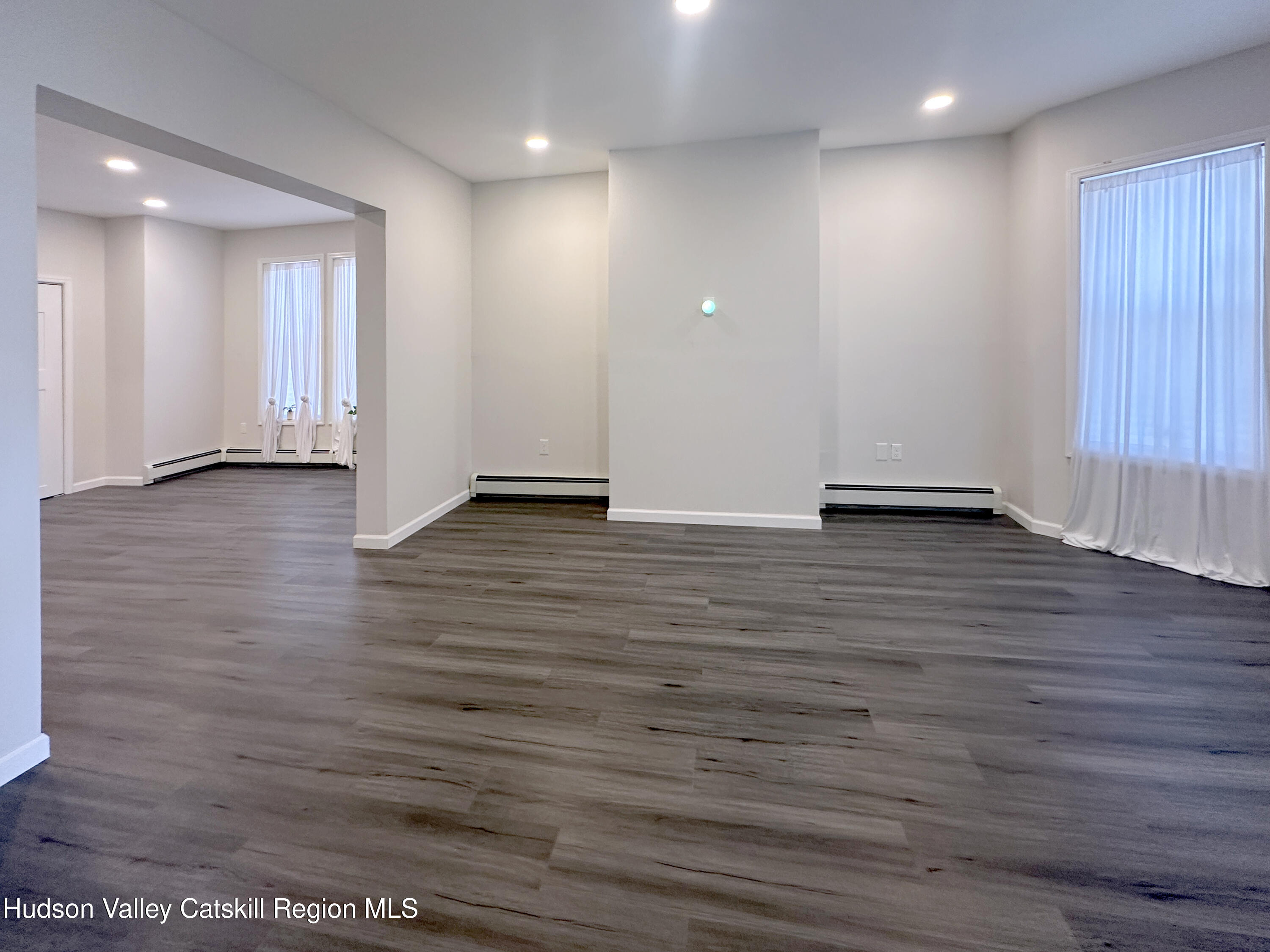 228 Mansion Street Poughkeepsie, NY 12601 - Photo 5 of 35 a view of an empty room with wooden floor
