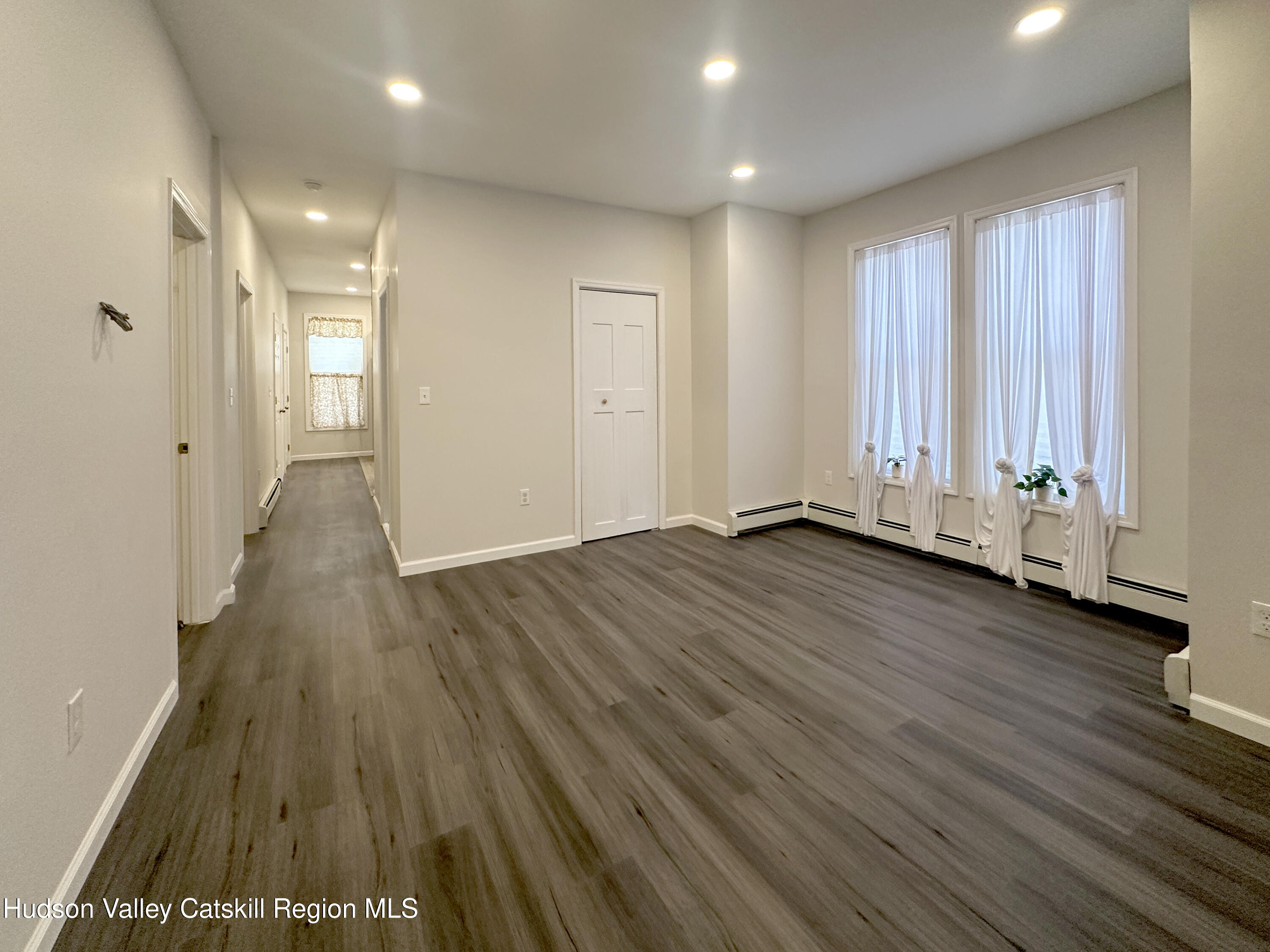 228 Mansion Street Poughkeepsie, NY 12601 - Photo 7 of 35 a view of an empty room with wooden floor and a window