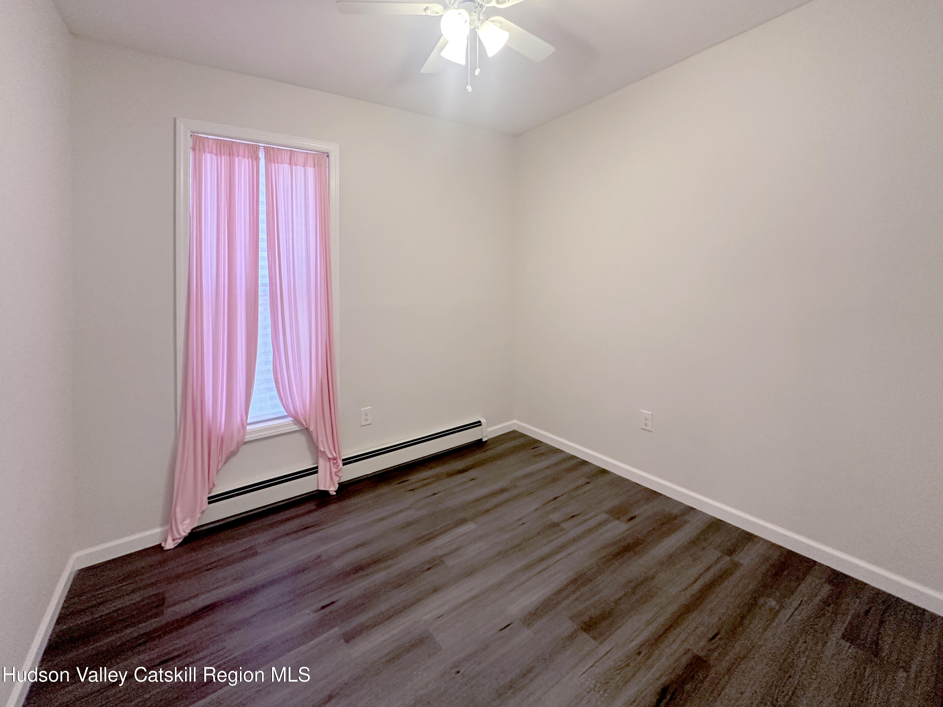 228 Mansion Street Poughkeepsie, NY 12601 - Photo 10 of 35 a view of a room with wooden floor and a window