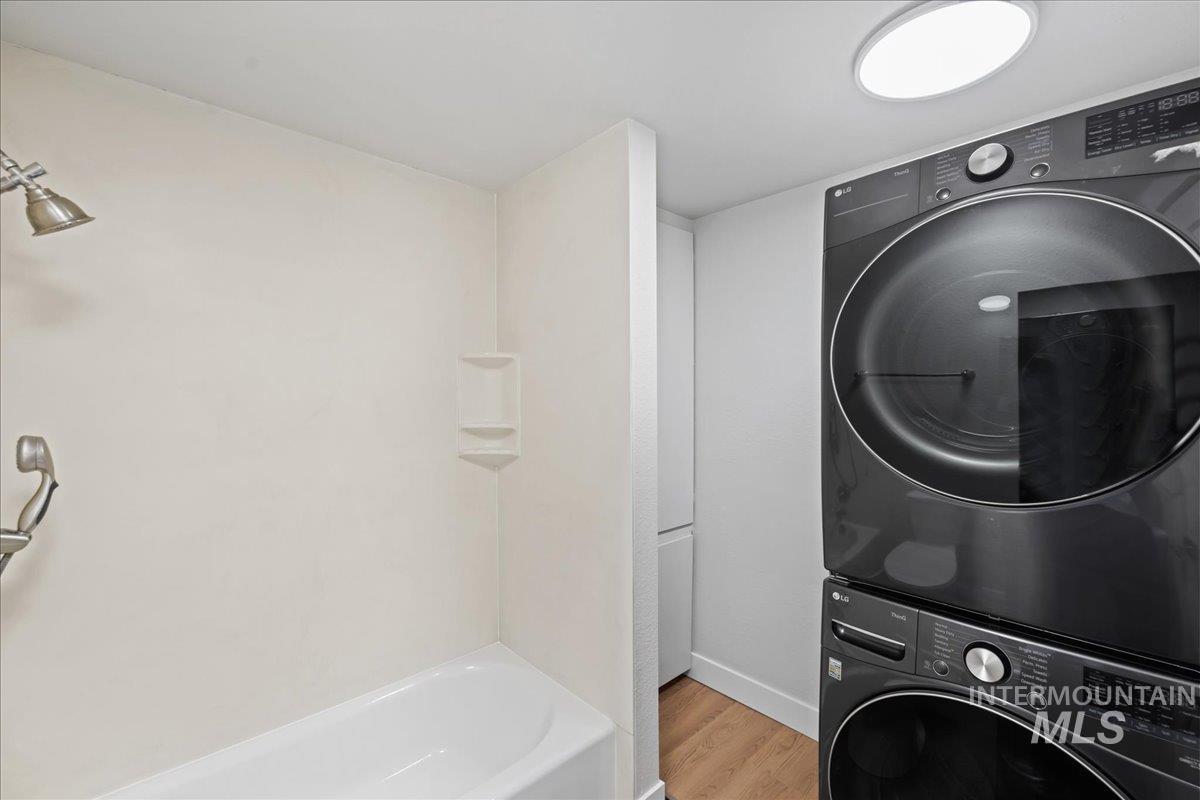 1309 West Maple Avenue Meridian, ID 83642 - Photo 14 of 50 Laundry area featuring light wood-type flooring and stacked washing machine and dryer