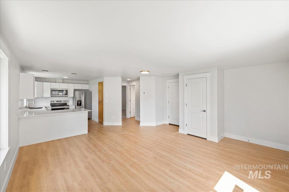 1309 West Maple Avenue Meridian, ID 83642 - Photo 27 of 50 Unfurnished living room featuring light wood-style flooring and recessed lighting
