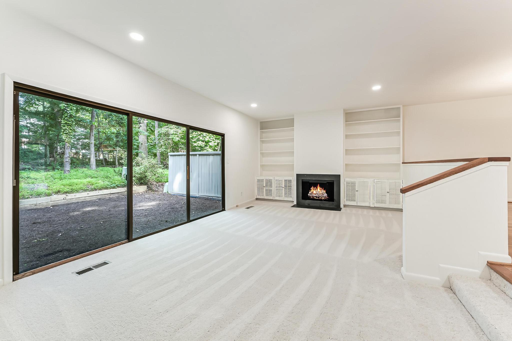 12023 Insha Court Reston, VA 20191 - Photo 32 of 52 a view of an empty room with a fireplace and a window