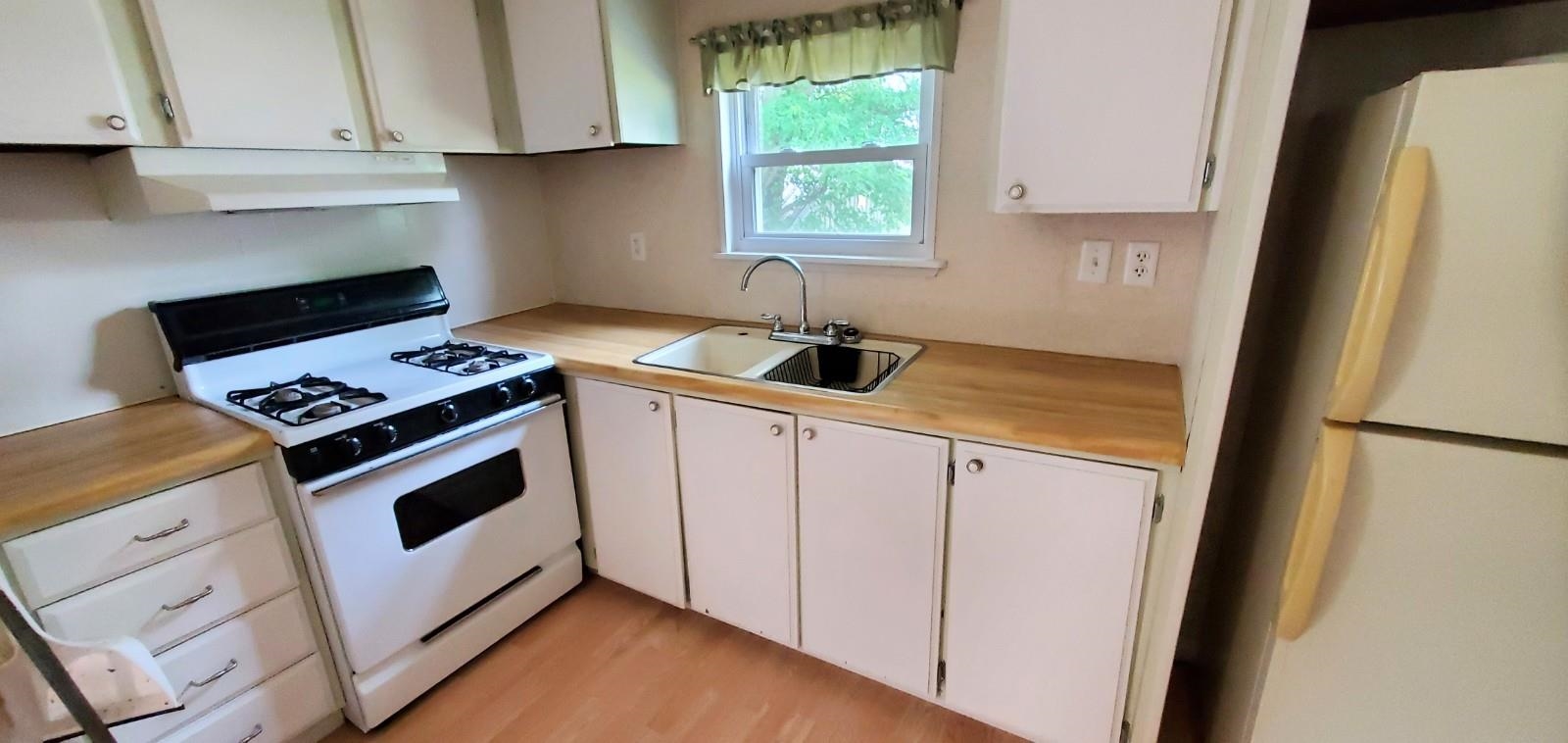 2182 Peek Home Road Dixon, IL 61021 - Photo 36 of 51 a kitchen with white cabinets and white appliances