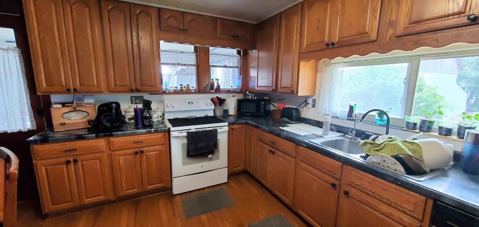 2182 Peek Home Road Dixon, IL 61021 - Photo 5 of 51 a kitchen with stainless steel appliances wooden cabinets a sink and a stove