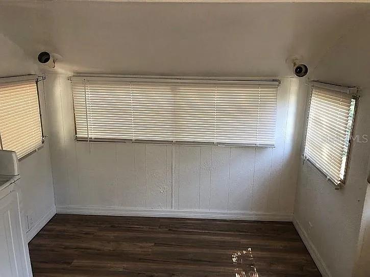 3000 Clarcona Road, Unit 401 Apopka, FL 32703 - Photo 9 of 15 a view of an empty room with wooden floor and a window