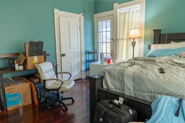 a bedroom with a bed and a chair