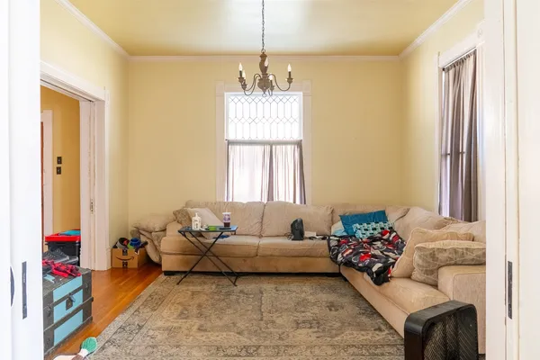 a living room with furniture and a chandelier