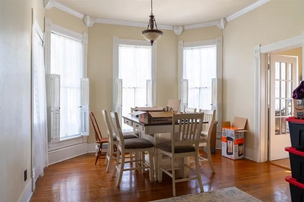 a view of a dining room with furniture and wooden floor