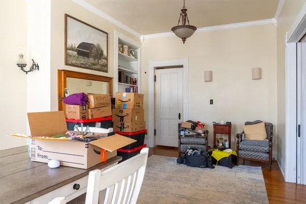 a living room with lots of toys and a wooden floor