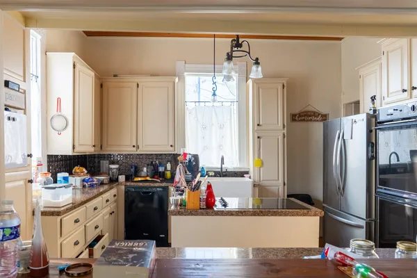 a kitchen with stainless steel appliances a refrigerator and a stove top oven