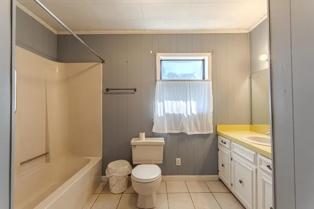 a bathroom with a granite countertop sink toilet a shower and a bathtub