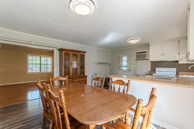 a view of a dining room with furniture and window