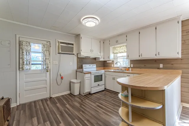 a kitchen with a refrigerator and white cabinets