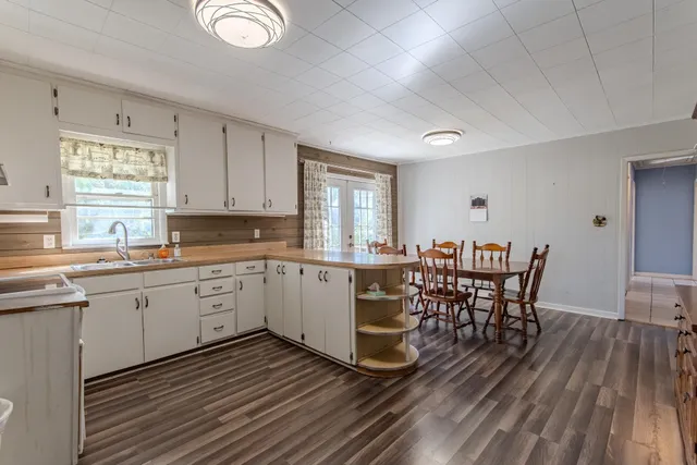 a kitchen with sink cabinets and wooden floor