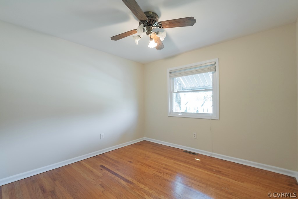 1593 Baxter Road Prince George, VA 23875 - Photo 17 of 29 wooden floor in an empty room with a window