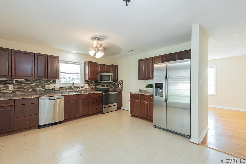 1593 Baxter Road Prince George, VA 23875 - Photo 3 of 29 a kitchen with granite countertop stainless steel appliances and wooden cabinets