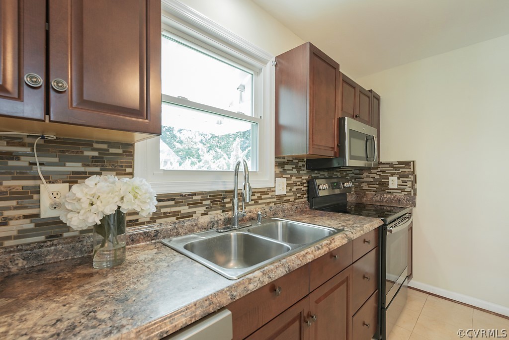 1593 Baxter Road Prince George, VA 23875 - Photo 5 of 29 a kitchen with stainless steel appliances a sink a stove and a microwave