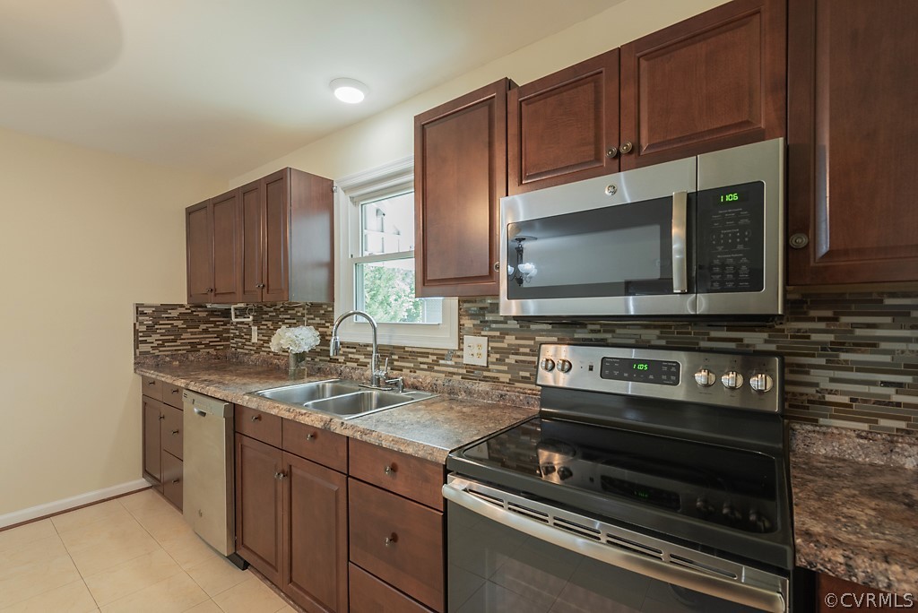 1593 Baxter Road Prince George, VA 23875 - Photo 6 of 29 a kitchen with wooden cabinets and a stove top oven