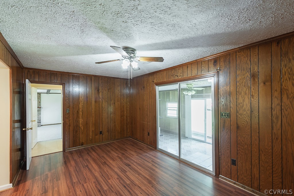 1593 Baxter Road Prince George, VA 23875 - Photo 8 of 29 an empty room with wooden floor fan and windows