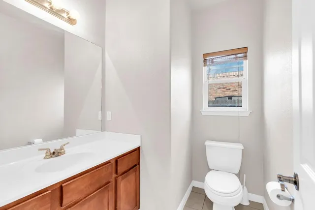 a bathroom with a sink mirror vanity and toilet