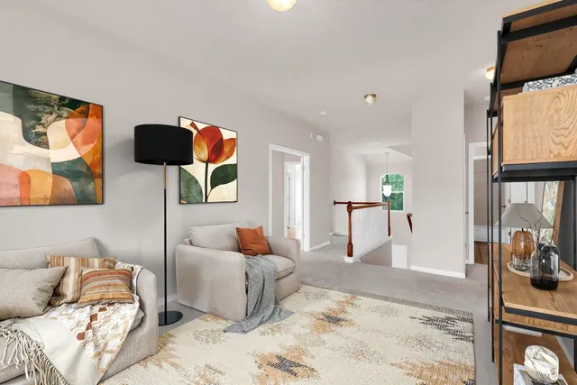 a living room with furniture and a painting on the wall