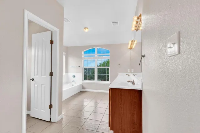 a bathroom with a sink a toilet and a shower