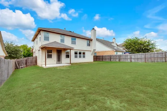 a view of a house with a backyard