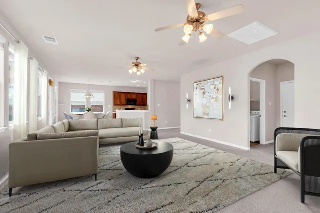 a living room with furniture and a chandelier