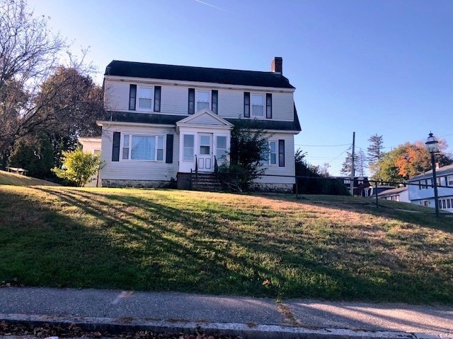 165 11th Street Lowell, MA 01850 - Photo 1 of 21 a front view of a house with a yard