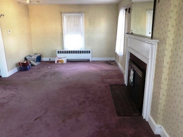 165 11th Street Lowell, MA 01850 - Photo 11 of 21 an empty room with a fireplace