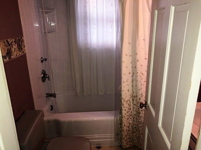 165 11th Street Lowell, MA 01850 - Photo 19 of 21 a bathroom with a bathtub and shower