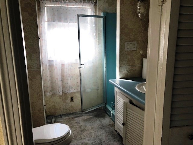 165 11th Street Lowell, MA 01850 - Photo 20 of 21 a bathroom with a toilet a sink and shower