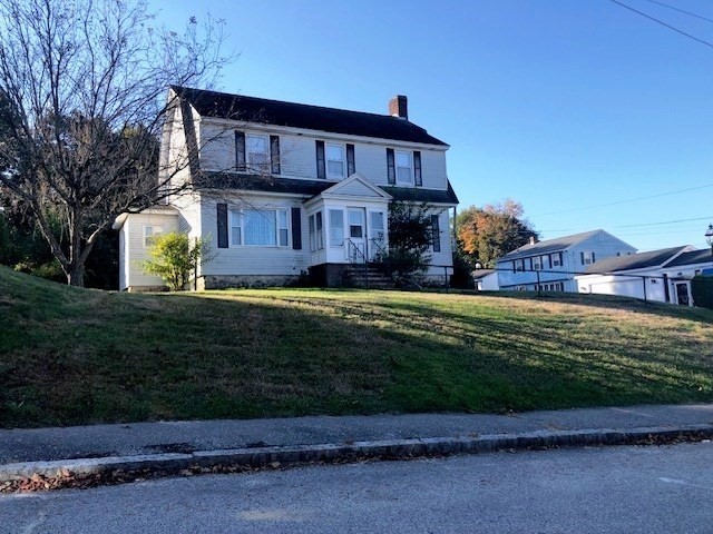 165 11th Street Lowell, MA 01850 - Photo 2 of 21 a front view of a house with a yard