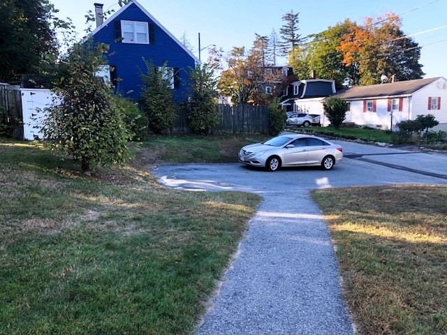 165 11th Street Lowell, MA 01850 - Photo 4 of 21 a view of a yard with cars