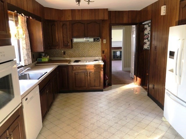 165 11th Street Lowell, MA 01850 - Photo 7 of 21 a kitchen with stainless steel appliances granite countertop a sink stove and refrigerator