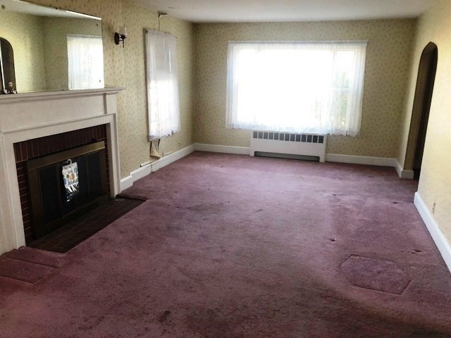 165 11th Street Lowell, MA 01850 - Photo 10 of 21 an empty room with windows and fireplace