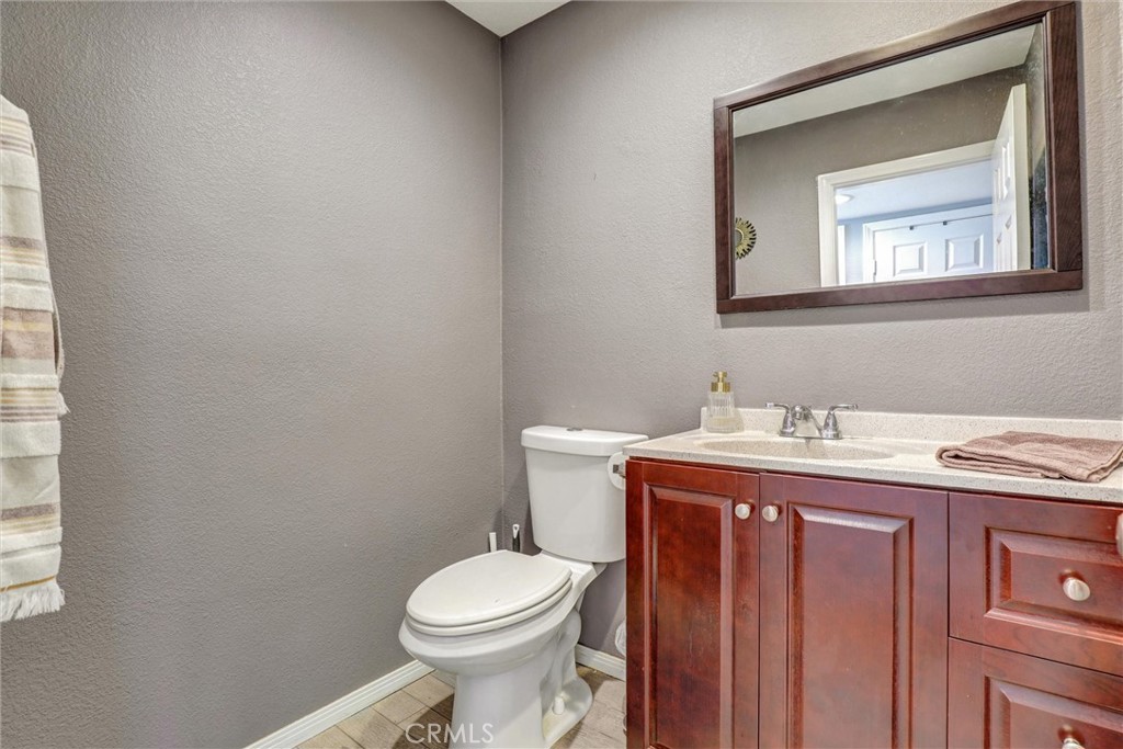 533 Walnut Avenue, Unit 7 Long Beach, CA 90802 - Photo 11 of 43 a bathroom with a granite countertop toilet a sink and mirror
