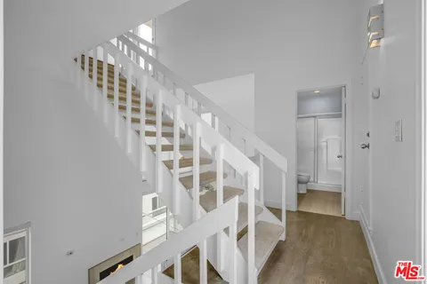 a view of entryway and hall with a front door