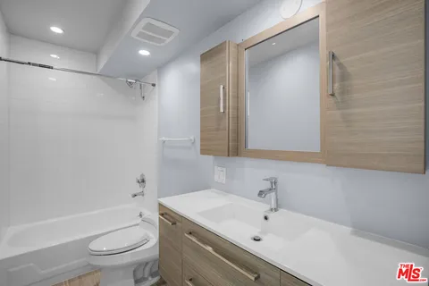 a bathroom with a sink a shower and a mirror
