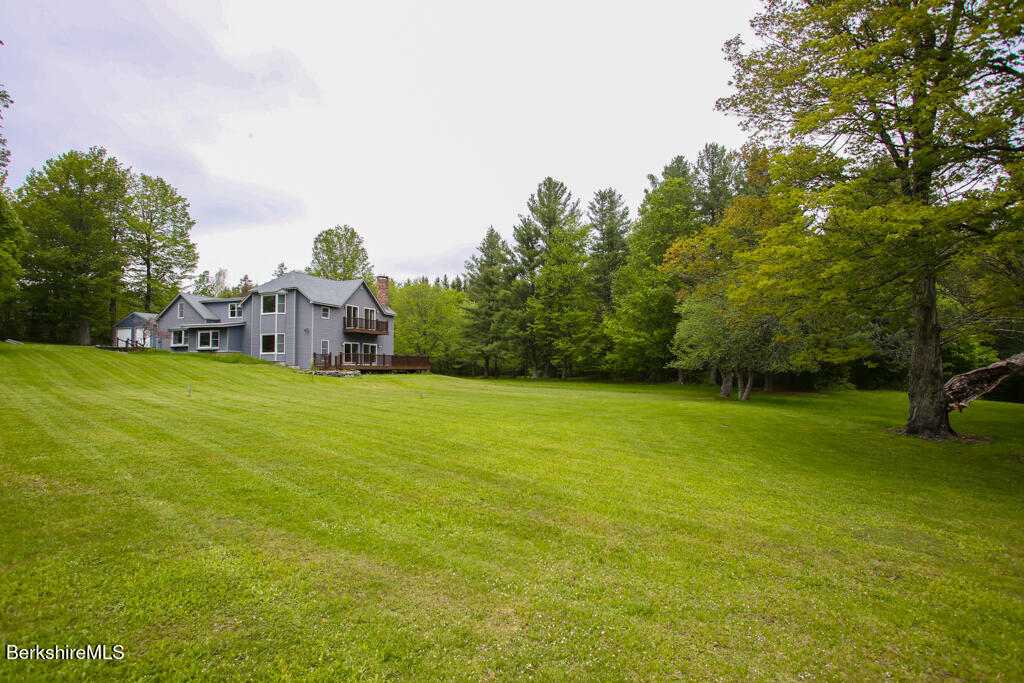 1271 Main Road Savoy, MA 01256 - Photo 5 of 38 a view of a yard with a house in the background