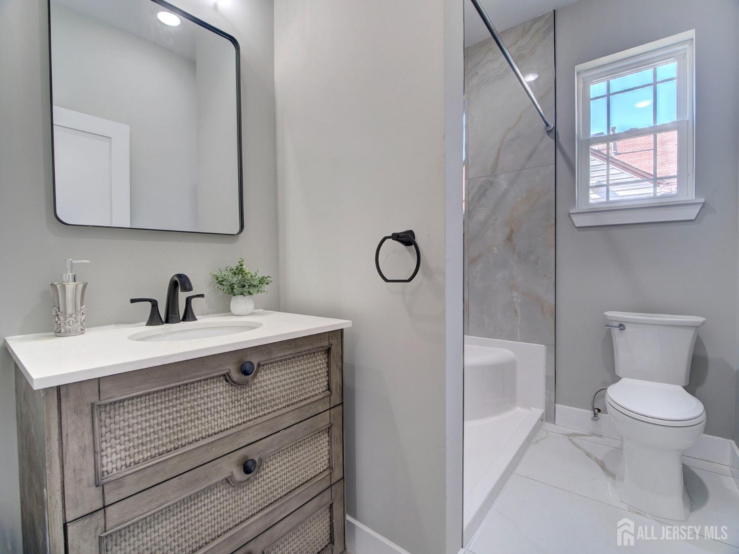 24 Stiles Road Edison, NJ 08817 - Photo 21 of 36 a view of bathroom with a toilet sink and mirror