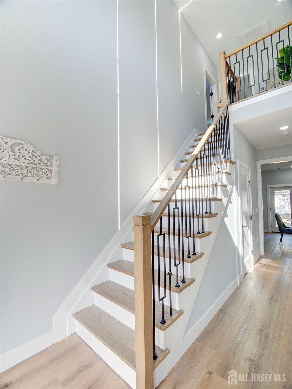 24 Stiles Road Edison, NJ 08817 - Photo 23 of 36 a view of staircase with lots of frames on wall and wooden floor