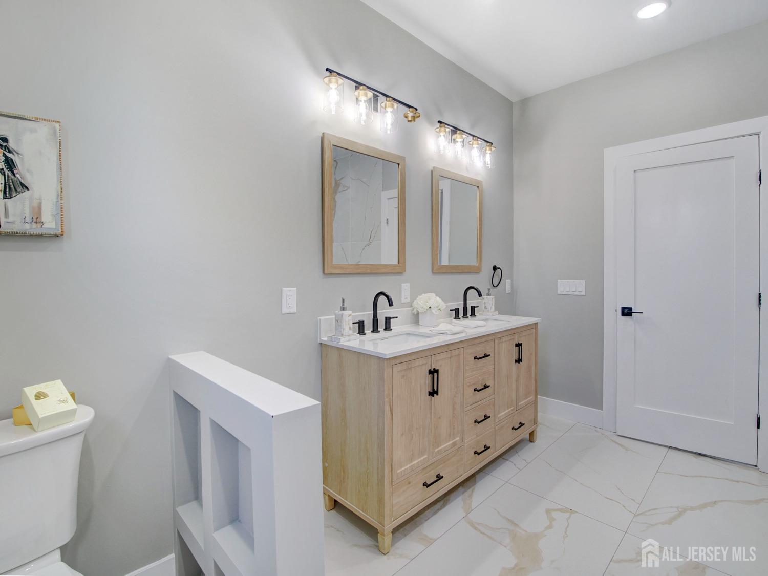 24 Stiles Road Edison, NJ 08817 - Photo 28 of 36 a bathroom with a double vanity sink and a mirror