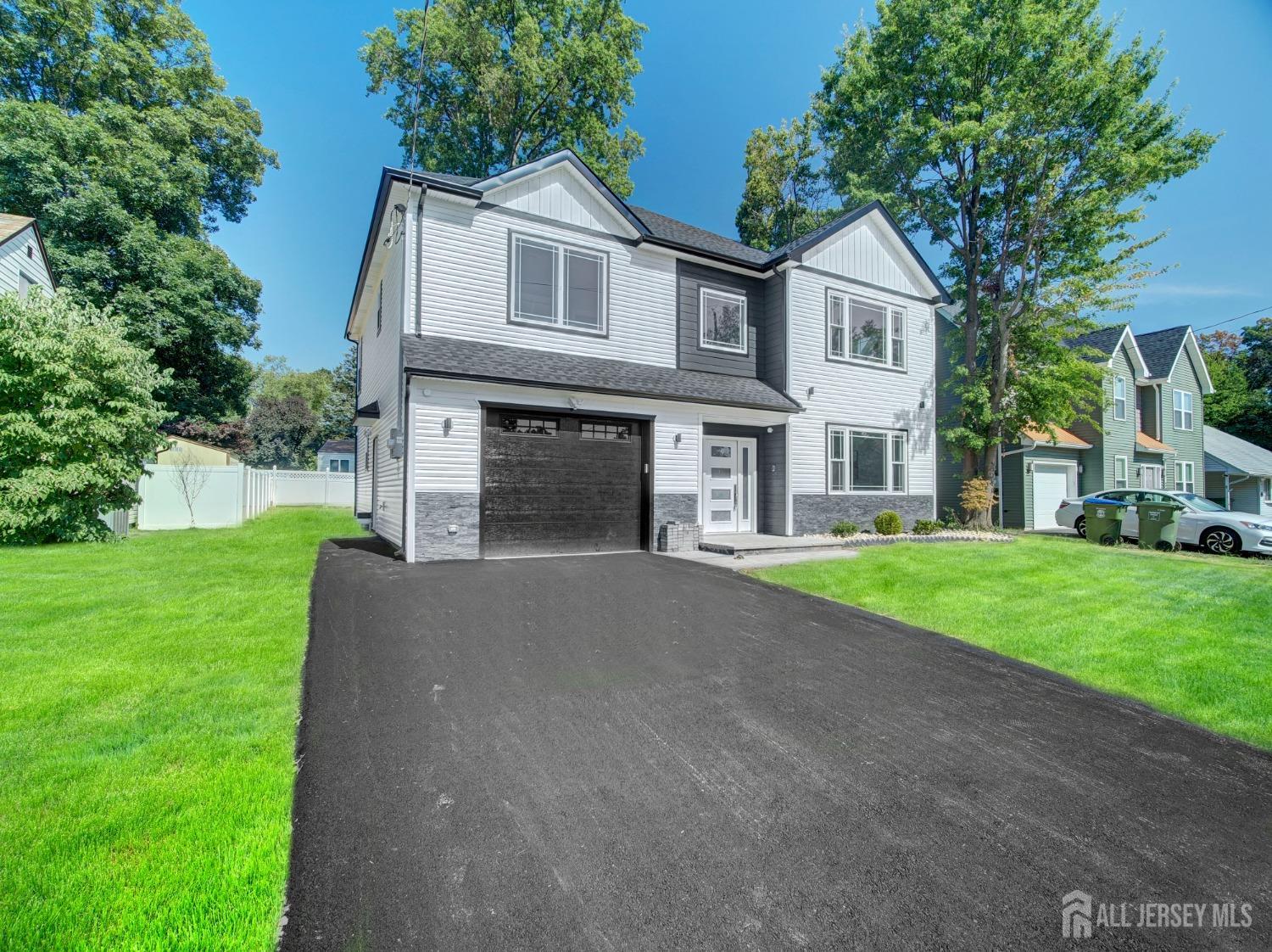 24 Stiles Road Edison, NJ 08817 - Photo 3 of 36 a front view of a house with a yard and garage
